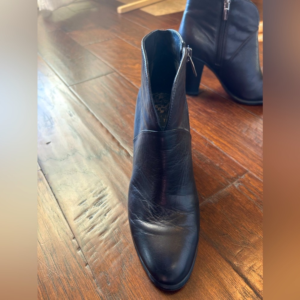 Vince Camuto black leather booties. Front notch cut out. 3.5 inch heel